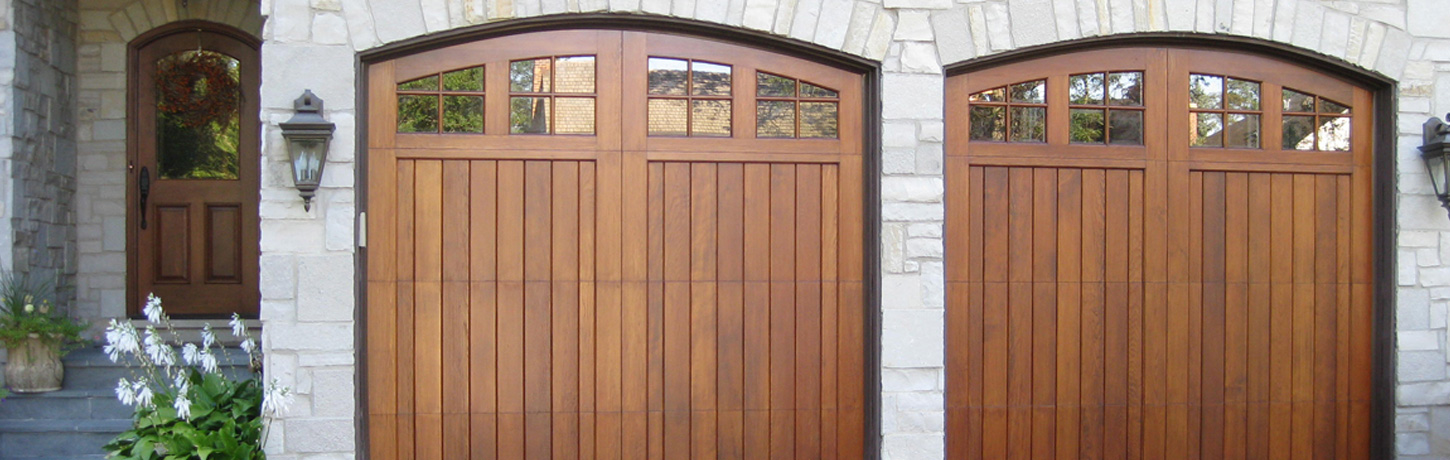 Custom arched wooden garage doors restored