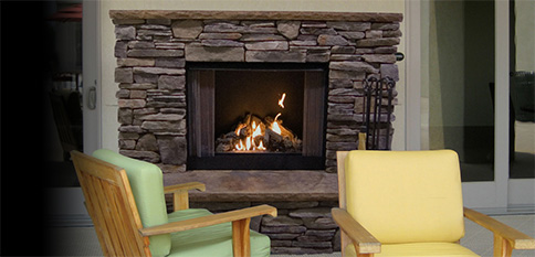 Stone fireplace with two wooden chairs